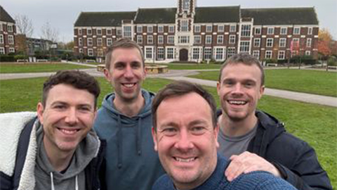 An image of Nick, Bradley, Joe and Mark at the Loughborough Campus with the Hazelrigg building in the background