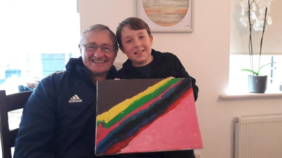 Bill Morley with grandson Ben, who is holding a painting