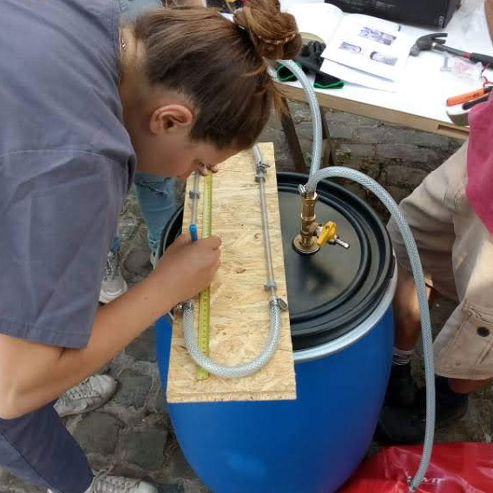 Dr Marianna Coulentianos building a low-tech biodigester (Brussels, July 2022) 