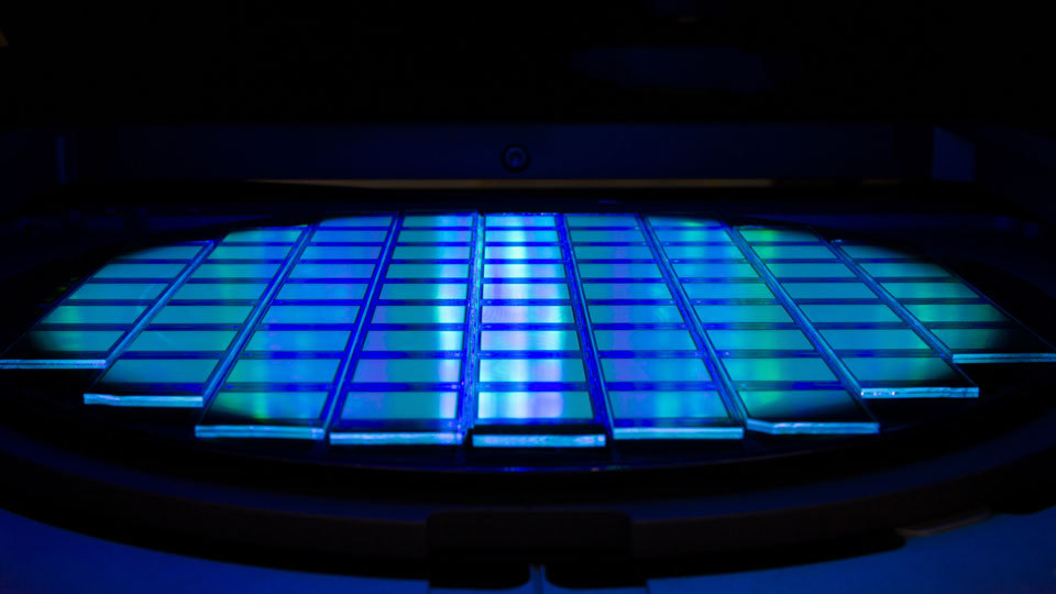 Silicon wafer with chips in UV lighting