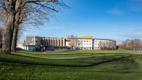 An exterior view of the Loughborough Business School building on a sunny day.