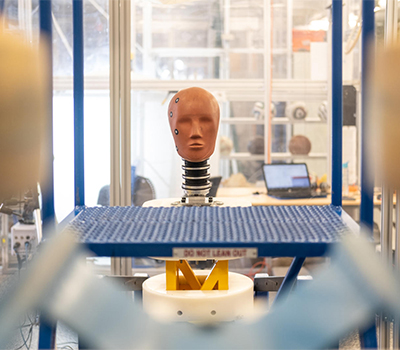 A human head prototype shot from a distance in a lab.