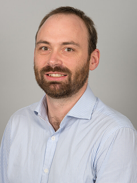 Headshot of Dr Peter Kinnell, smiling whilst looking directly at the camera.