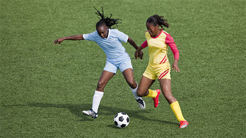 Two women playing football