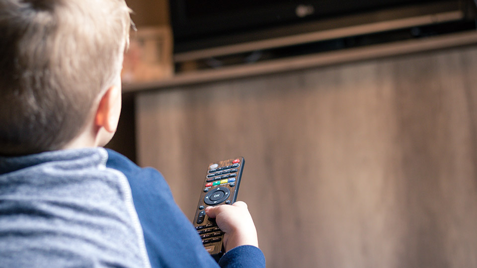 Pictured is a child watching tv. 