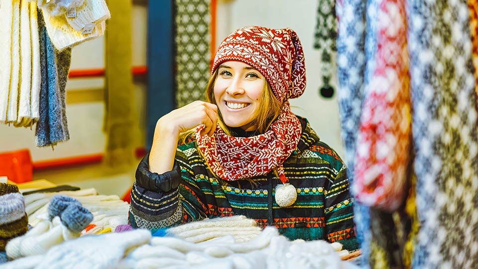 Pictured is a knit-maker at a stall. 