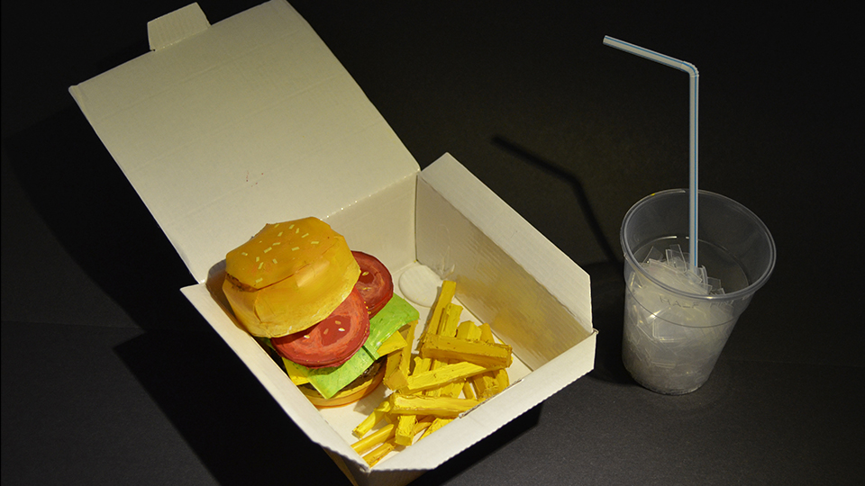 photo of student Maisie's work - a 'burger and chips meal' made entirely out of plastic cups
