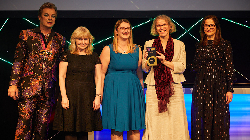 Photo of Academic Registry team members collecting their award at the Times Higher Education awards