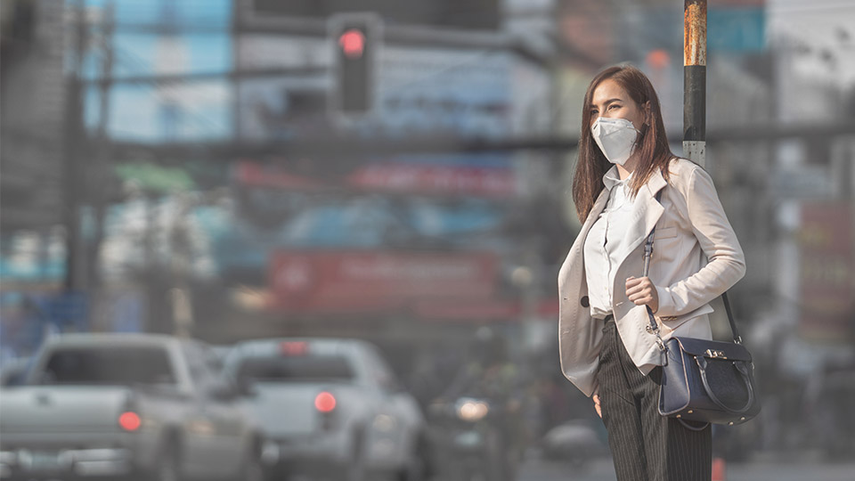 Woman with an air pollution mask on.