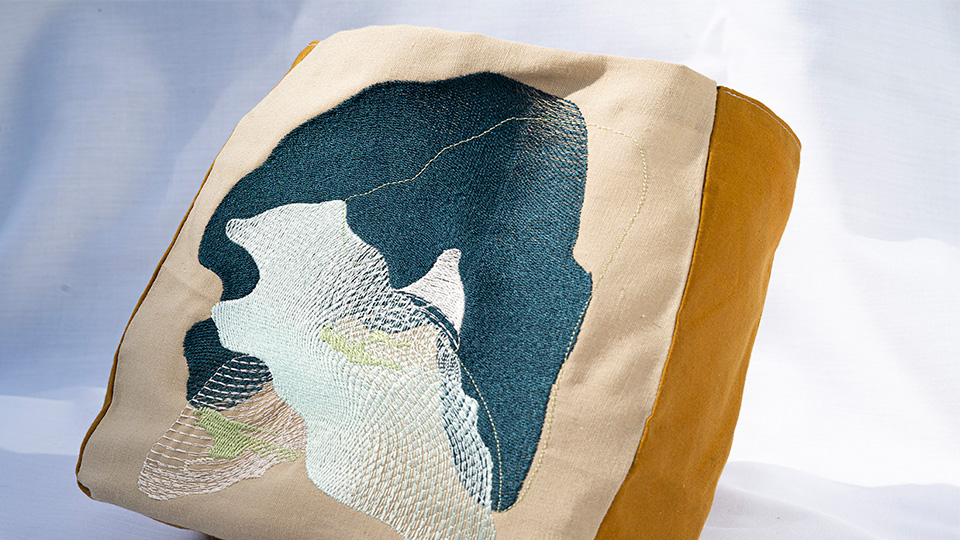 Unrooted bag, made by Alice using biodegradable digital embroidery, reclaimed fabric and water-resistant oil cloth.