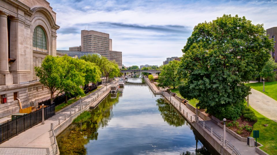 Urban scene of buildings and Rideau canal, cloudy sky in background. HDR effect.

