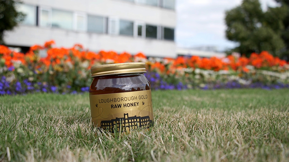 photo of 2018 Loughborough Gold honey jar in grass on Loughborough campus