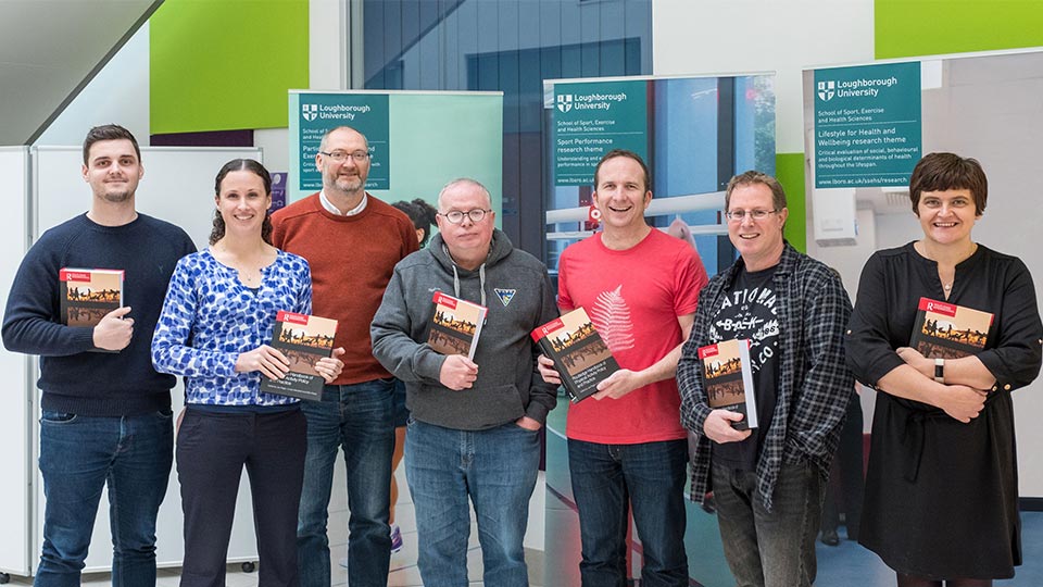 Pictured, from left to right, are Dr Andrew Kingsnorth, Dr Lauren Sherar, Prof Paul Downward, Prof Alan Bairner, Dr Joe Piggin, Dr Dominic Malcolm and Dr Carolynne Mason holding copies of the Routledge Handbook of Physical Activity Policy and Practice.