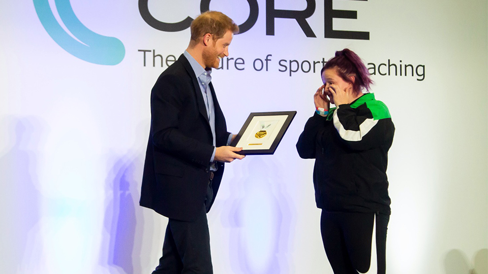 photo of Prince Harry awarding a graduating coach with an award at the ceremony at Loughborough University 