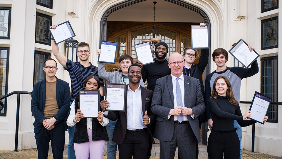 photo of scholarship students with Vice Chancellor Robert Allison outside the Hazlerigg Building