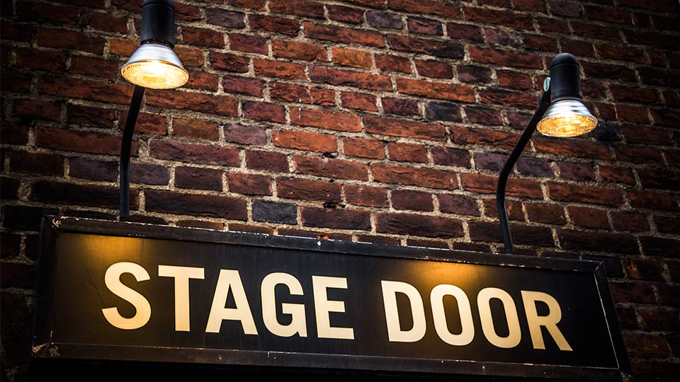 Pictured is a stage door sign. 
