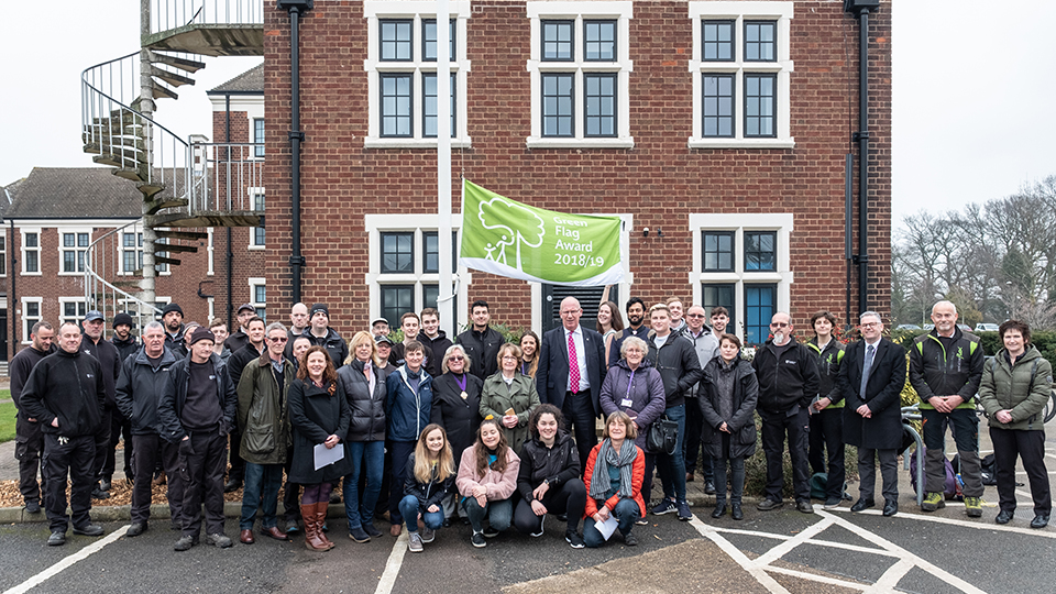 photo of Green Flag and University staff and students outside Hazlerigg and Rutland buildings