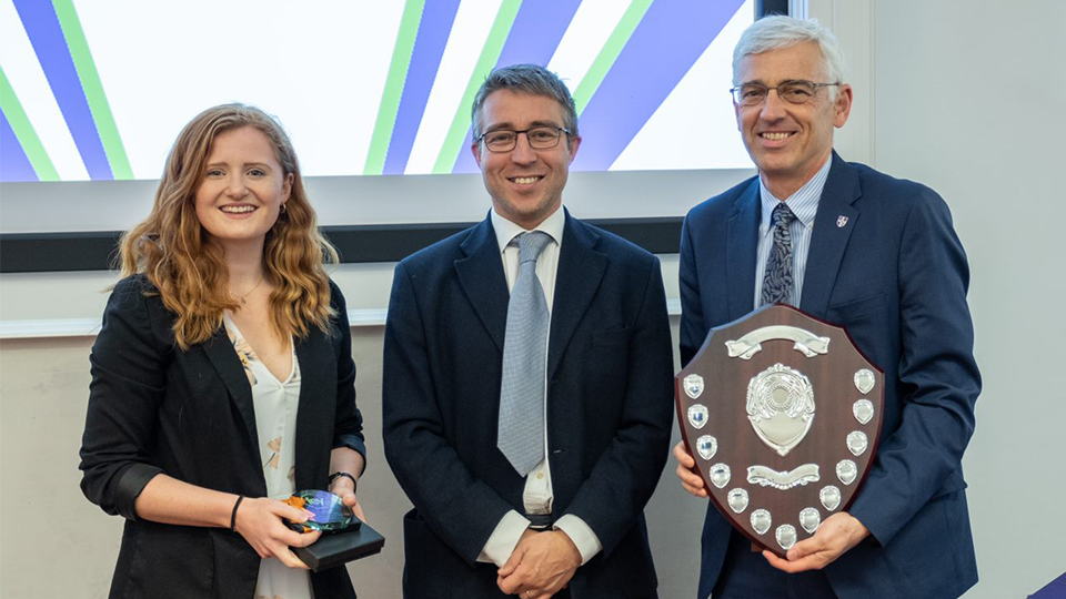 Photo of UG winner Hannah accepting her award, with Guy Blundell and Professor Chris Rielly