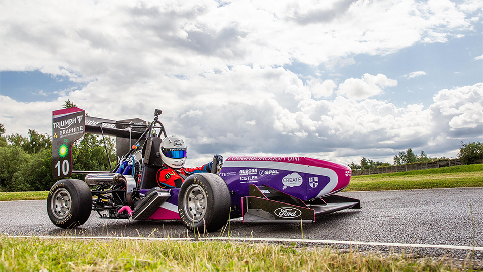 Photo of the 2019 car on race track with driver