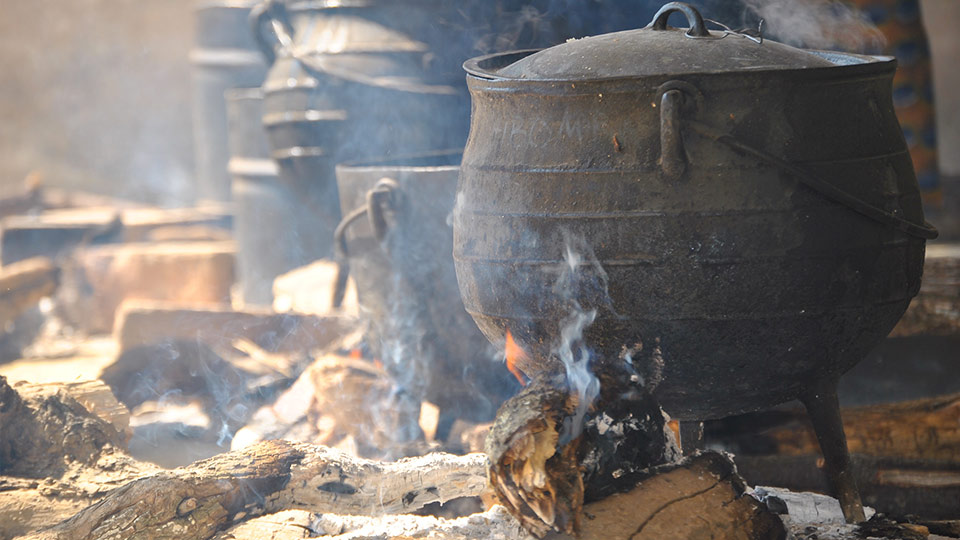 A pot cooking on wood fuel. 