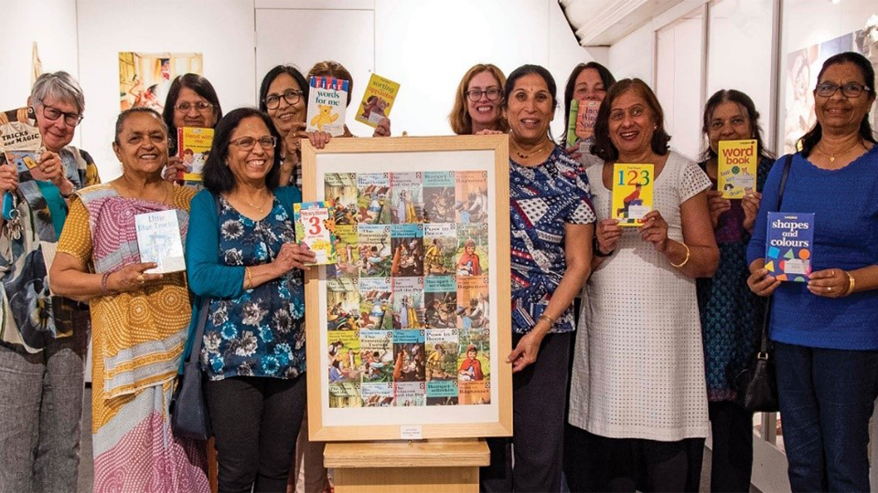 photo of a group of women holding Ladybird Books and facing the camera