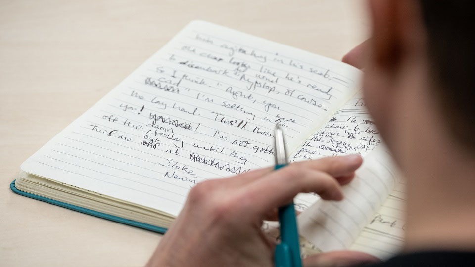 photo of notebook with handwriting in