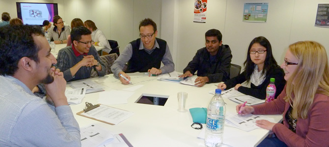 Image of doctoral researchers in a development workshop in Graduate House.