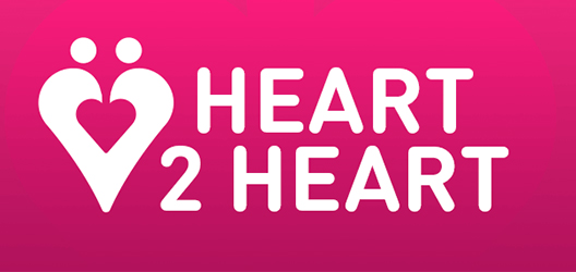 Pictured are the words Heart 2 Heart on a pink back ground with a heart icon. 