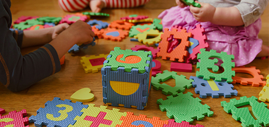 photo of children playing with a number jigsaw game