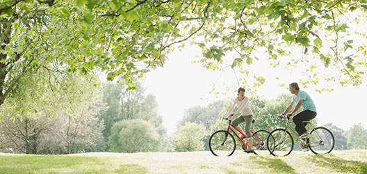 photo of a couple on bikes in a park