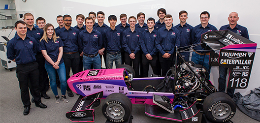 photo of the LU Motorsport team in front of the 2018 racing car