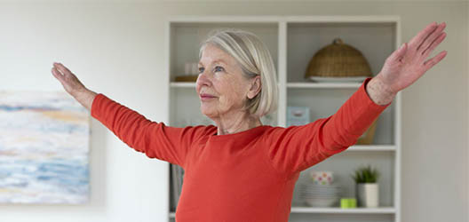 Older woman doing exercise at home