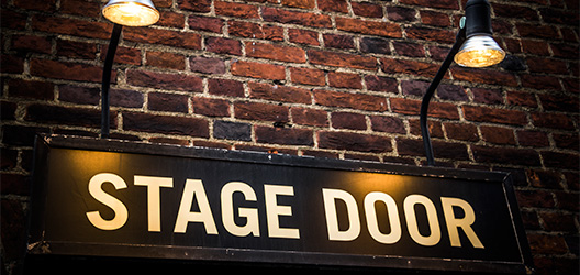Pictured is a stage door sign. 