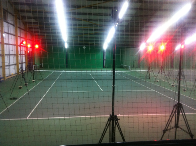 Photo of an indoor tennis court set up with Vicon infrared marker cameras ready to capture data.