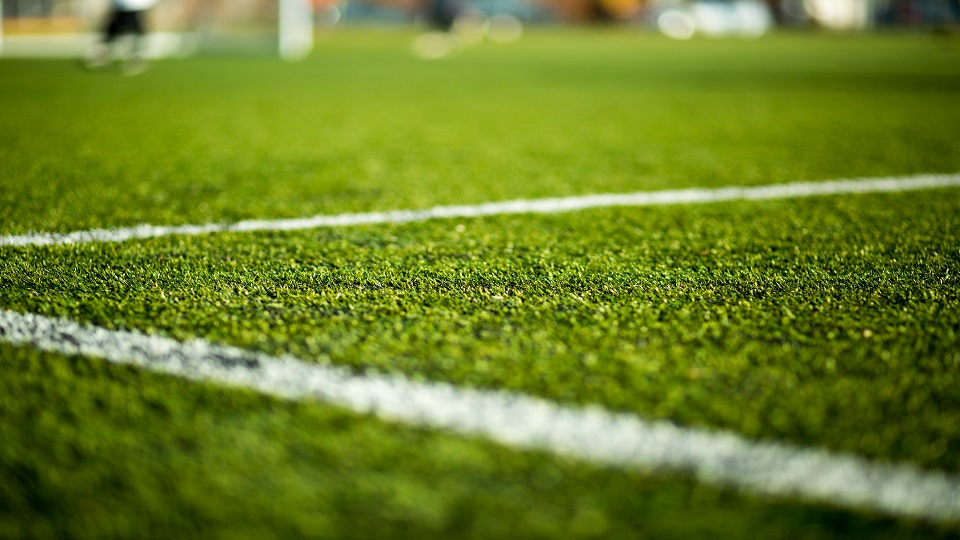 A close up of an artificial football pitch.
