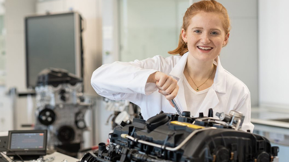 Hannah working on building an engine.