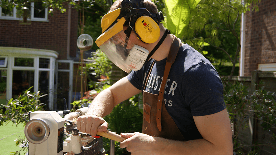 Lewis working on a lathe machine.