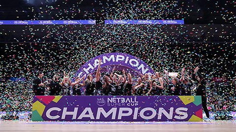 lightning netball team lifting the super cup trophy