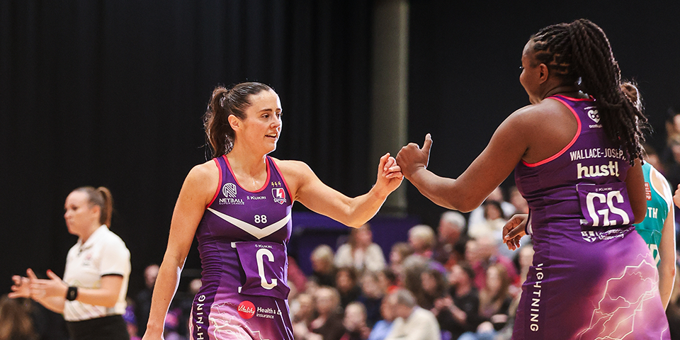 Jess Shaw and Sammy Wallace Joseph fist bumping as they walk past each other