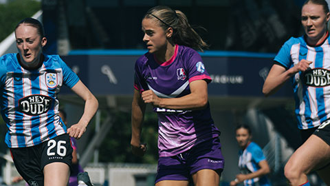 A lightning football player and Huddersfield players on pitch mid game