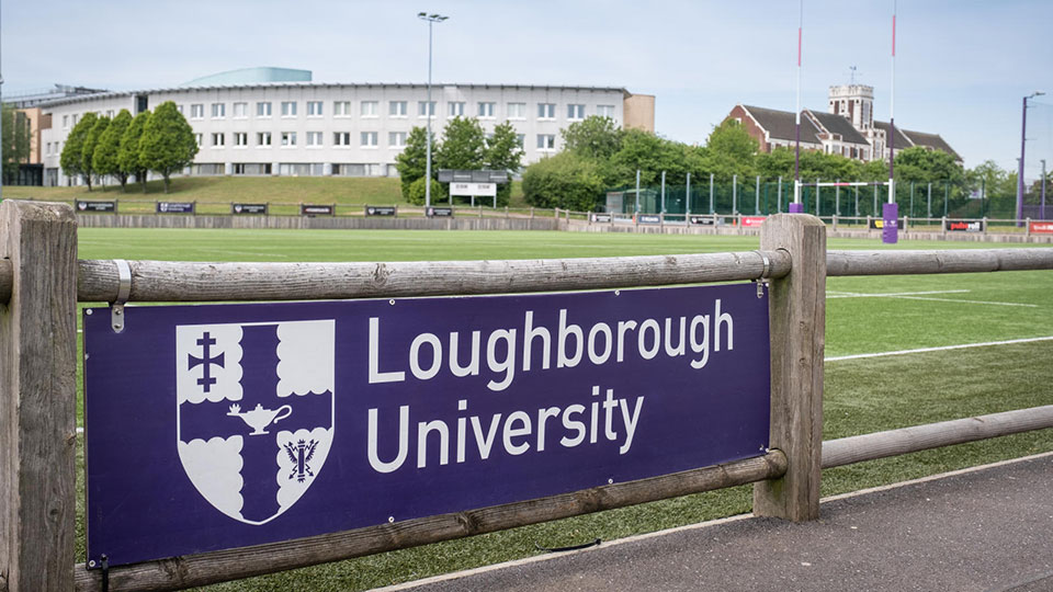 A Loughborough University sign on the side of a rugby pitch