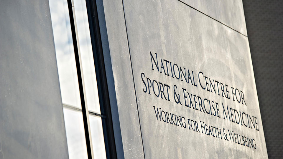 The words 'National Centre for Sport and Exercise Medicine, working for health and wellbeing' engraved on the wall of the NCSEM building