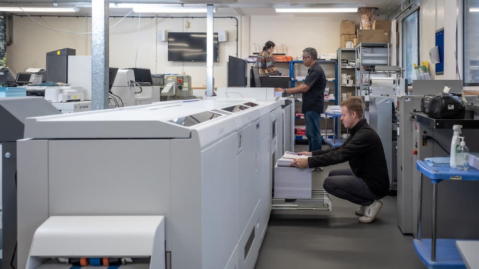 People at a large printer