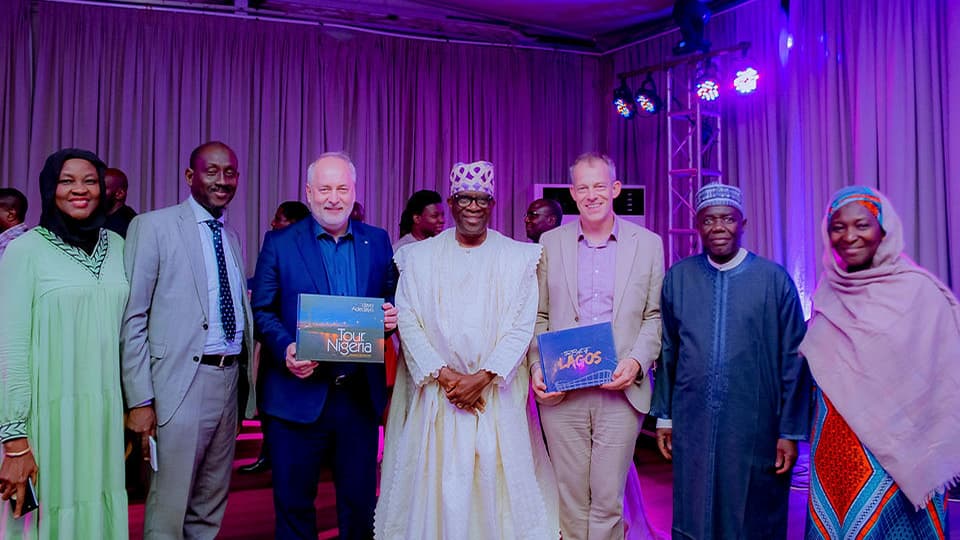 Several people standing smiling