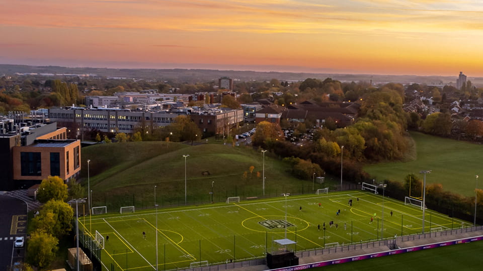 Sunrise over campus and sports pitches