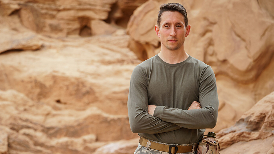 Jonathan Broom-Edwards stands with arms folded