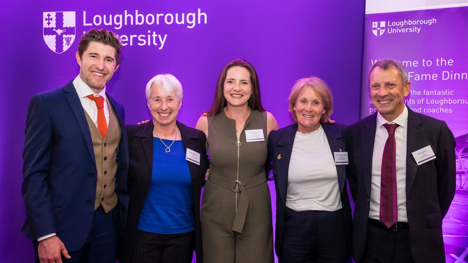 Five of the 2022 Hall of Fame inductees: Phil Burgess, Emma Mitchell, Goldie Sayers, Penny Briscoe and Jack Buckner all standing together in front of a purple background