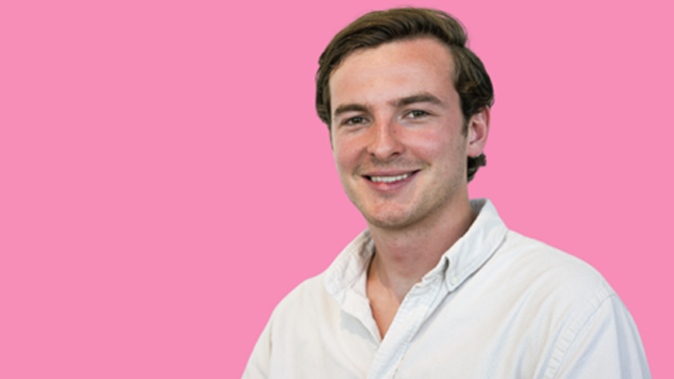 Pink background headshot of Ronan Harvey-Kelly