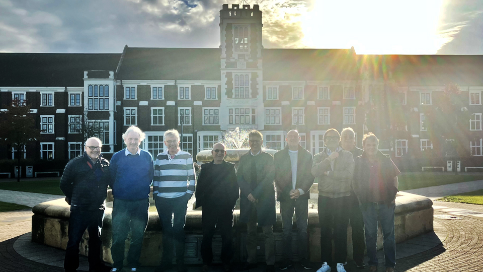 A group of people standing outside the Hazlerigg Building