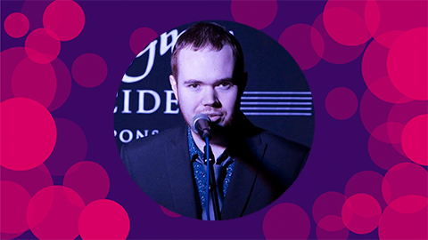 A purple background with pink circles on with a headshot of David Luck in the middle of the canvas.